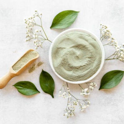 Blue clay cosmetic powder and mask in bowls. top view.