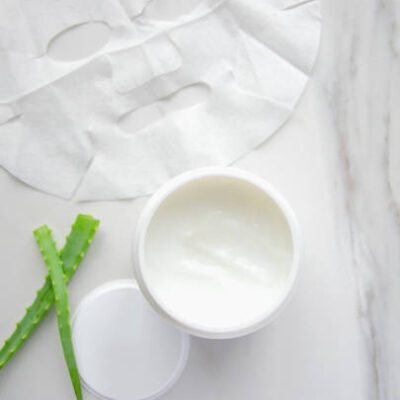 White bottle with cream and aloe vera.cosmetics on marble table